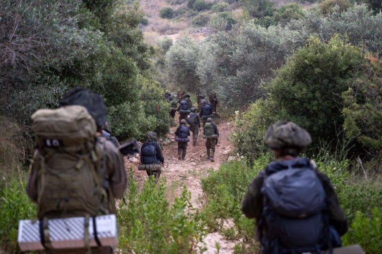 a group of people walking on a dirt path
