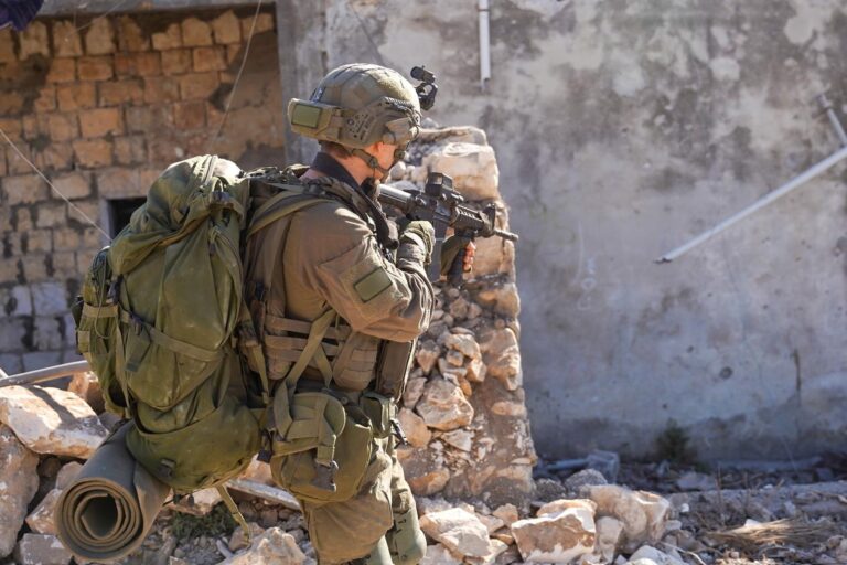 a man in military uniform holding a gun