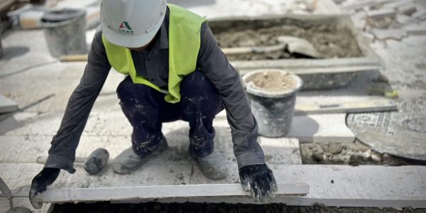 a man wearing a hard hat and safety vest